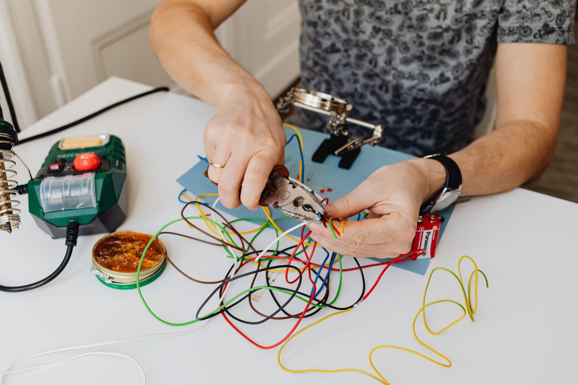 Electrician's hands wiring a power outlet